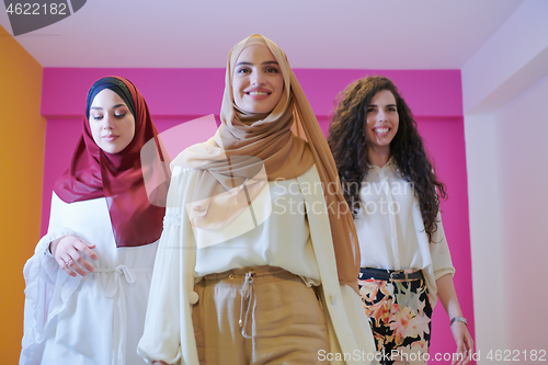 Image of muslim women in fashionable dress isolated on pink