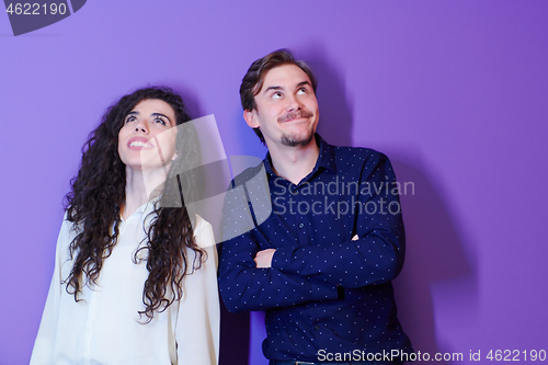 Image of portrait of young couple isolated over purple background