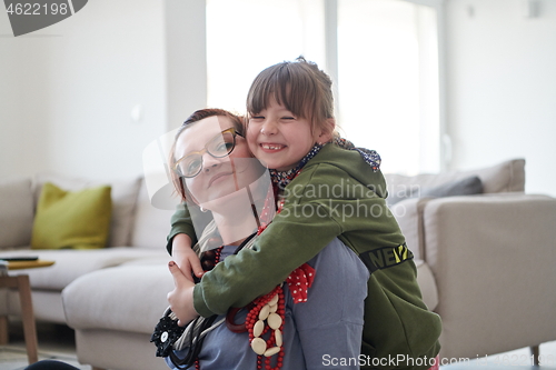 Image of Mother and little girl daughter playing with jewelry  at home