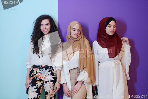 Image of muslim women in fashionable dress isolated on colorful backgroun