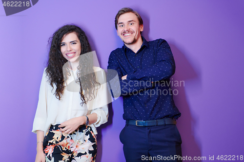 Image of portrait of young couple isolated over purple background