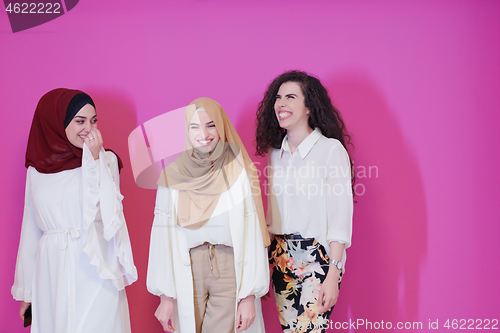 Image of muslim women in fashionable dress isolated on pink