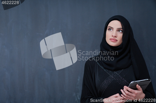 Image of young modern muslim business woman using tablet computer