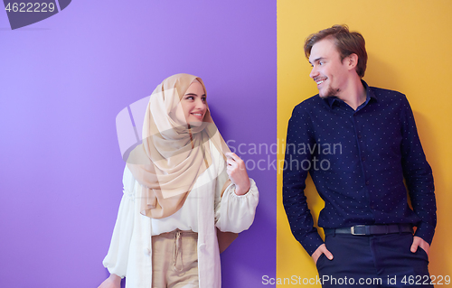 Image of portrait of young muslim couple isolated on colorful background
