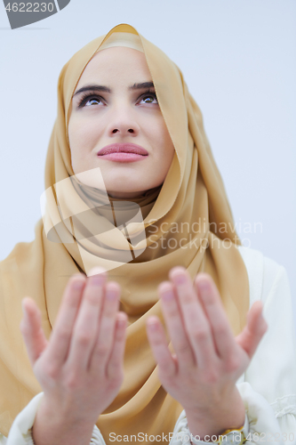 Image of muslim woman making traditional prayer to God