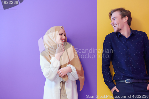 Image of portrait of young muslim couple isolated on colorful background