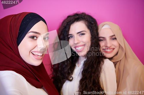 Image of muslim women in fashionable dress isolated on pink