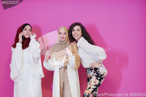 Image of muslim women in fashionable dress isolated on pink