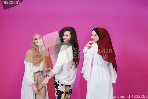 Image of muslim women in fashionable dress isolated on pink