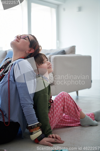 Image of Mother and little girl daughter playing with jewelry  at home