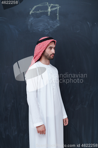 Image of portrait of arabian man in front of black chalkboard