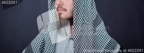 Image of portrait of arabian man in front of black chalkboard