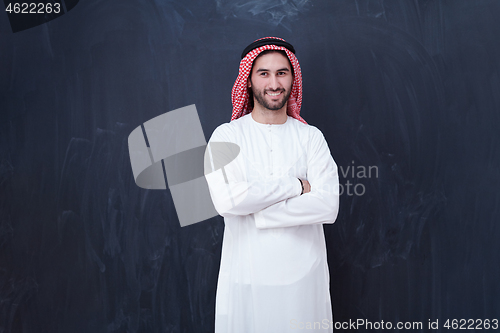 Image of portrait of arabian man in front of black chalkboard