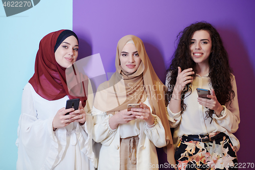 Image of muslim women in fashionable dress isolated on colorful backgroun