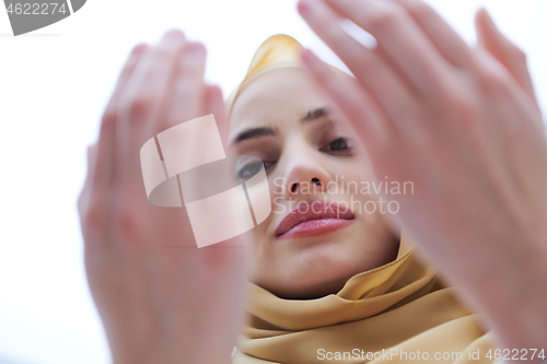 Image of muslim woman making traditional prayer to God