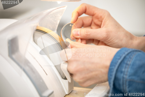 Image of woman hone the edge of the eyeglasses