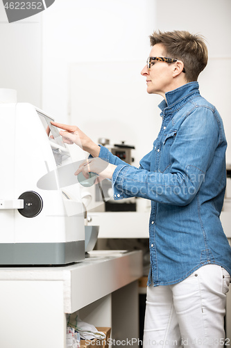 Image of woman hone the edge of the eyeglasses