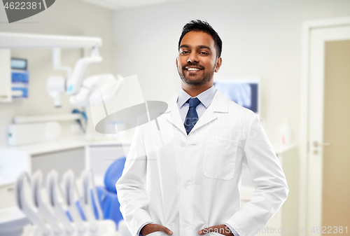 Image of indian male dentist in white coat at dental clinic