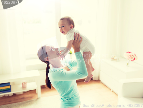 Image of happy young mother with little baby at home