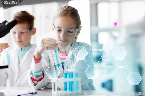 Image of kids with test tubes studying chemistry at school