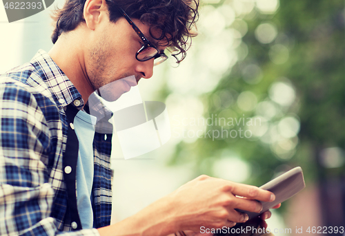 Image of close up of man with tablet pc outdoors