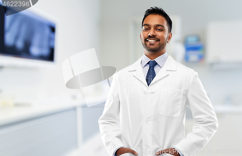 Image of indian male dentist in white coat at dental clinic