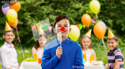 Image of happy boy with red clown nose at birthday party