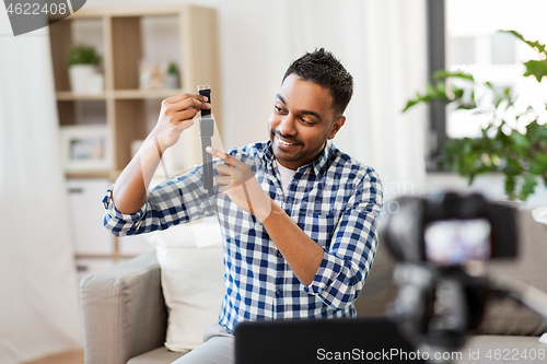 Image of male blogger with smart watch recording video blog