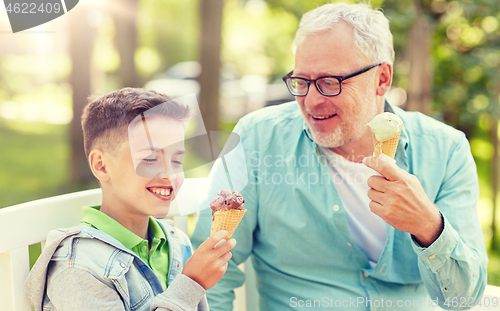 Image of old man and boy eating ice cream at summer park