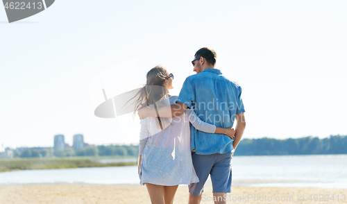 Image of happy couple hugging on summer beach