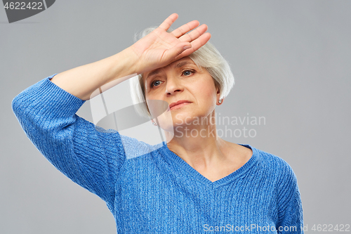 Image of tired senior woman suffering from headache