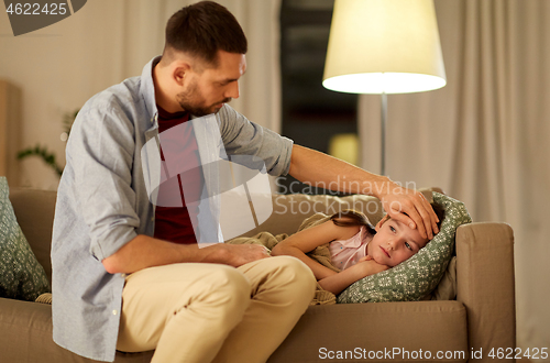 Image of father taking care of ill daughter at home