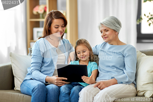 Image of mother, daughter and grandmother with tablet pc