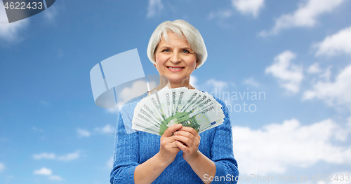 Image of senior woman with hundreds of euro money banknotes