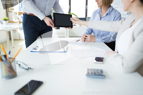 Image of close up of business team with tablet pc at office