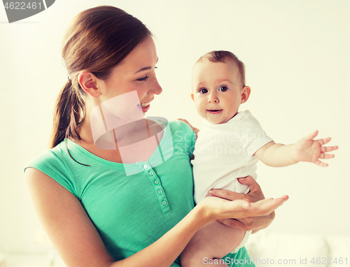 Image of happy young mother with little baby at home