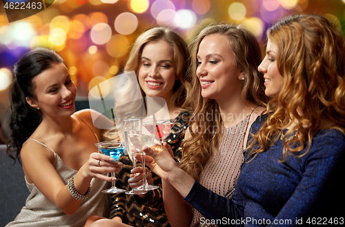 Image of happy women clinking glasses at night club