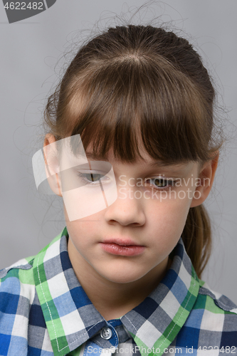 Image of Portrait of a sad ten-year-old girl of European appearance, close-up