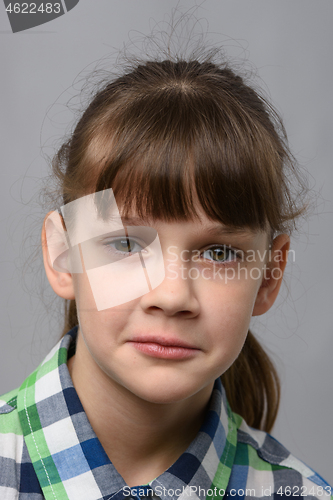 Image of Portrait of a sad ten-year-old girl of European appearance, close-up