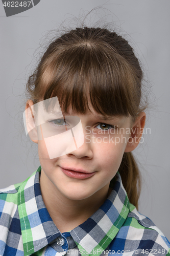 Image of Portrait of embarrassed ten-year-old girl, European appearance, close-up