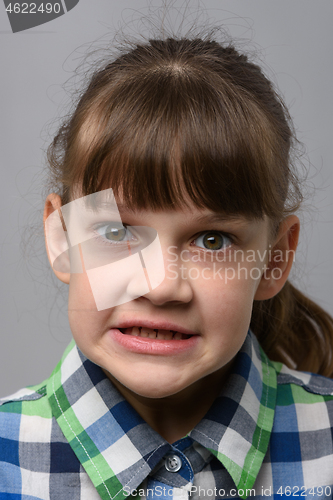 Image of Portrait of an evil ten-year-old girl of European appearance, close-up