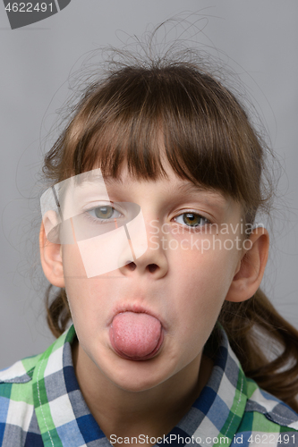 Image of Portrait of a ten-year-old girl who shows offended language, European appearance, close-up