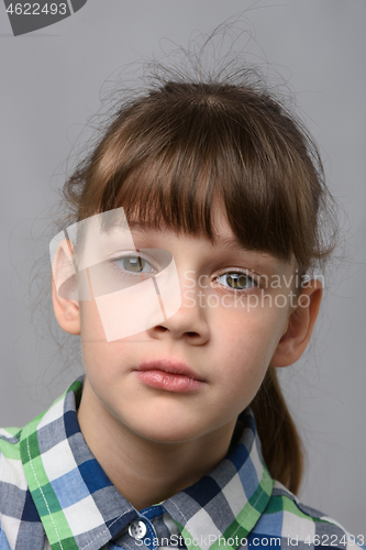 Image of Portrait of a compassionate ten-year-old girl of European appearance, close-up