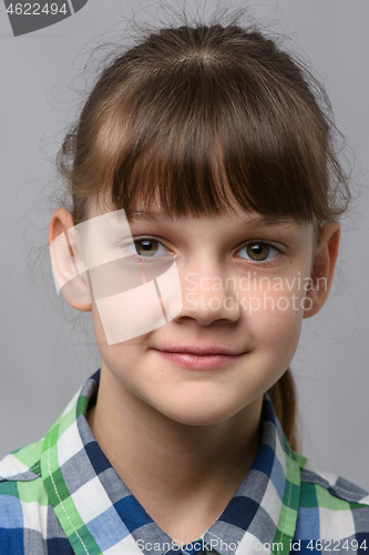 Image of Portrait of a happy ten year old girl of European appearance, close-up