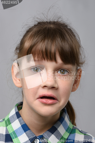 Image of Portrait of a puzzled ten-year-old girl of European appearance, close-up