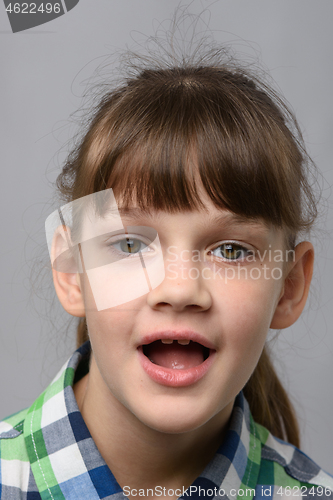 Image of Portrait of a funny ten-year-old girl with wide mouth, European appearance, close-up