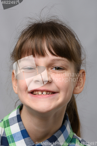 Image of Portrait of a funny smiling ten-year-old girl of European appearance, close-up