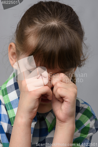 Image of Portrait of a roaring ten-year-old girl of European appearance, close-up