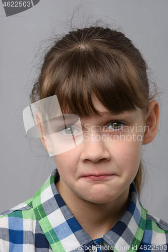 Image of Portrait of a ten-year-old girl with a pitying look, European appearance, close-up