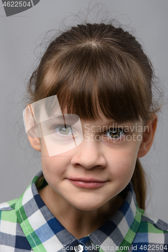 Image of Portrait of a fun surprised ten year old girl of European appearance, close-up